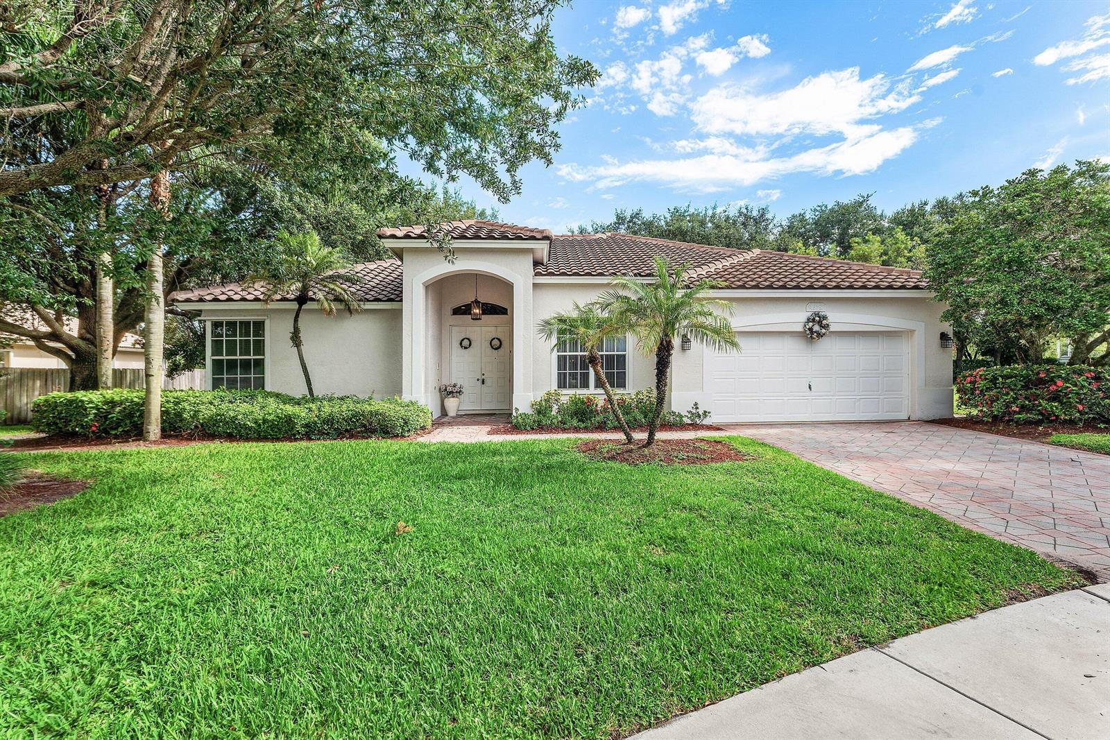 A single-story stucco house with a tile roof, a two-car garage, and a landscaped yard — 4378 Danielson Drive, Lake Worth FL 33467, LAKE WORTH, FL