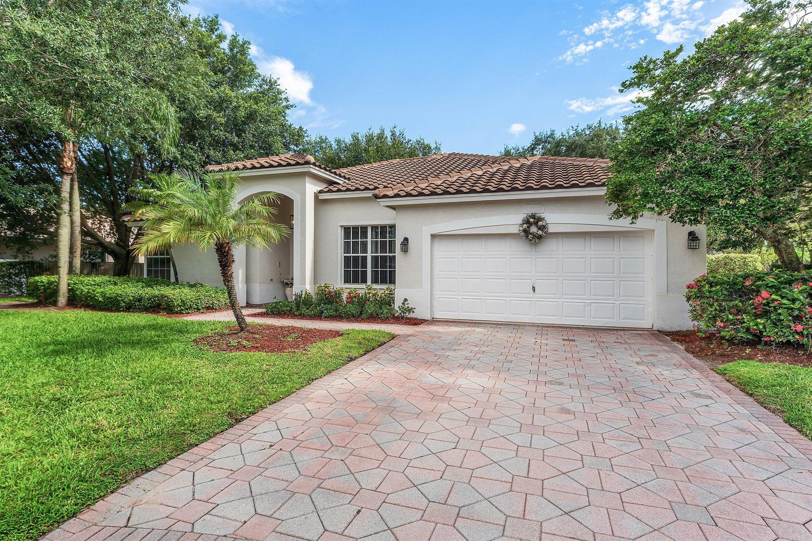 A single-story house with a tiled roof, a paved driveway, and a two-car garage — 4378 Danielson Drive, Lake Worth FL 33467, LAKE WORTH, FL