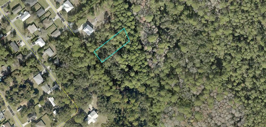 This is an aerial map view showing a rectangular lot highlighted in a wooded area — 0 SUNSET BOULEVARD, ST AUGUSTINE, FL