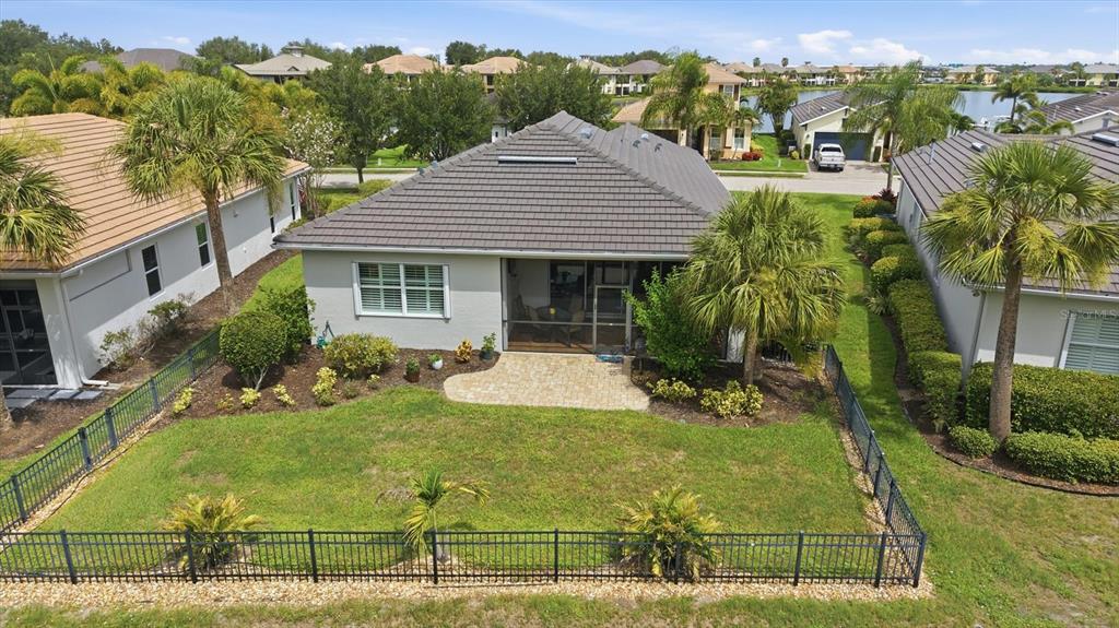 A single-story house with a gray garage door, a paved driveway, and a green lawn — 5029 LAKE OVERLOOK AVENUE, BRADENTON, FL