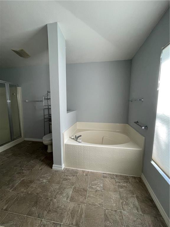 A bathroom features a tiled soaking tub, a separate shower, and a toilet — 1435 9th Place, Vero Beach FL 32960, VERO BEACH, FL