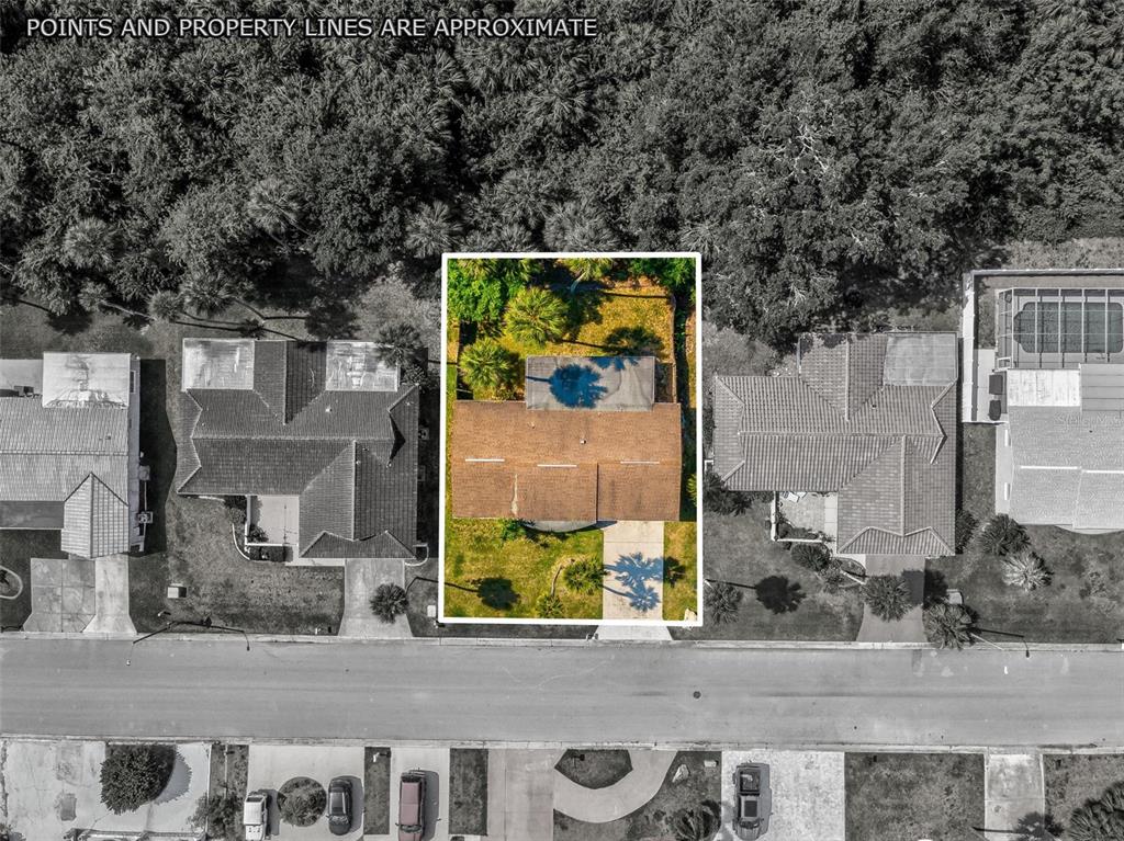 An aerial view shows a single-family house with a brown roof and a fenced backyard — 4408 RUDDER WAY, NEW PORT RICHEY, FL