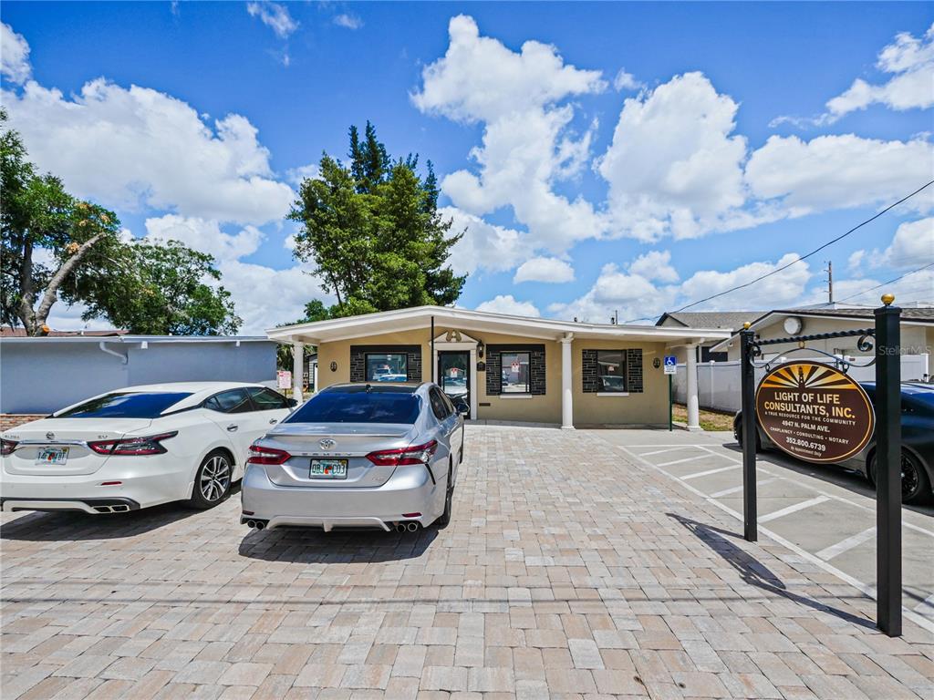 A single-story commercial building with a paved parking lot and a business sign in front — 4947 N PALM AVENUE, WINTER PARK, FL
