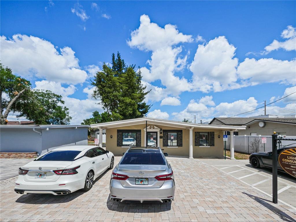 A single-story building with a paved parking lot and two cars parked in front — 4947 N PALM AVENUE, WINTER PARK, FL