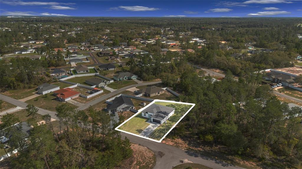 An aerial view shows a single-story house with a white outline on a corner lot — 4411 SW 172ND STREET ROAD, OCALA, FL