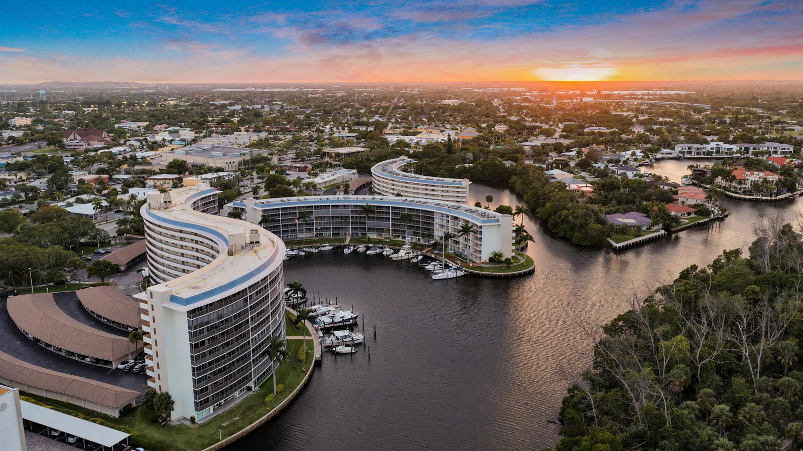 An aerial view of two curved waterfront apartment buildings with a private boat marina — 1537 E Hillsboro Boulevard # 341, Deerfield Beach FL 33441, DEERFIELD BEACH, FL