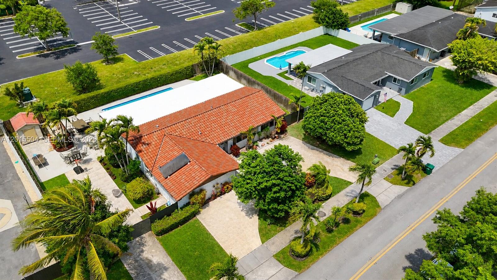 An aerial view shows two houses with swimming pools, palm trees, and a parking lot — 10435 SW 92nd St, Miami FL 33176, MIAMI, FL