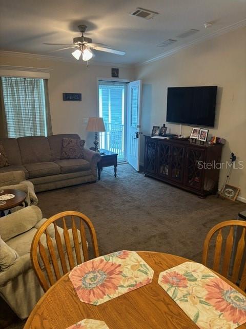 A living room features a sofa, a television on a console, and a dining table — 9000 US HWY 192 UNIT 56, CLERMONT, FL