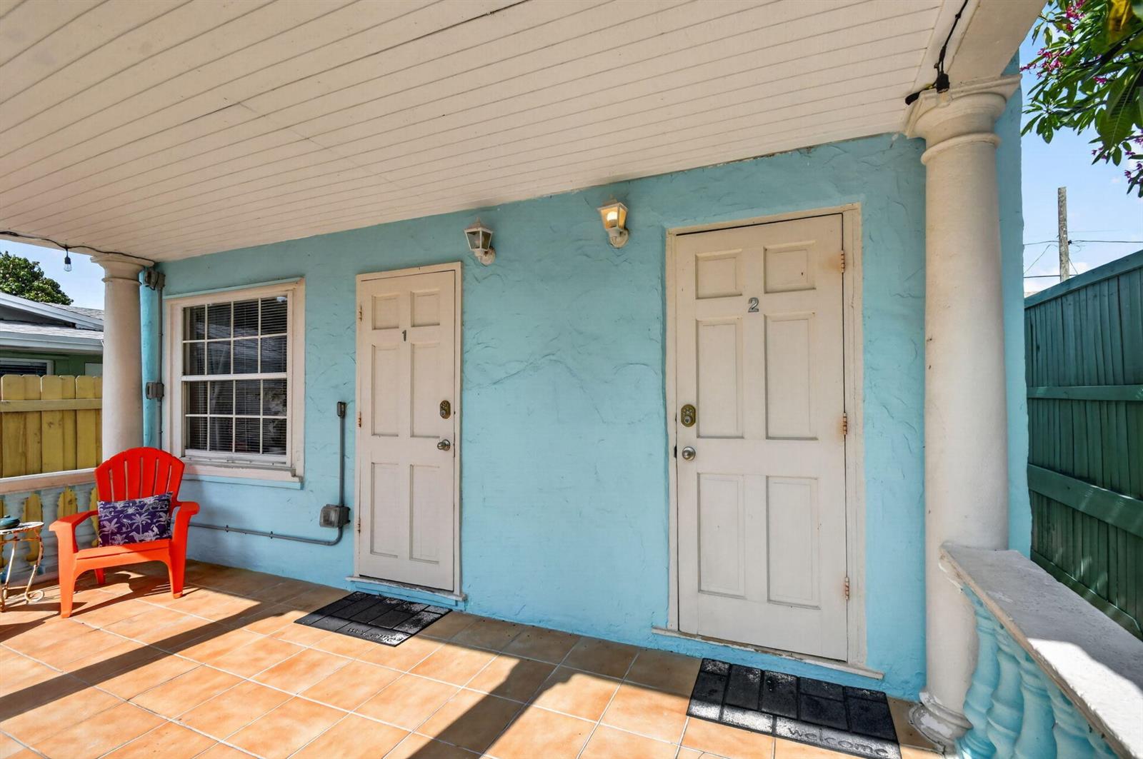 A light blue exterior wall features two white doors numbered one and two — 508 N K Street # 1, FL 33460, FL
