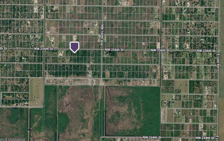 This is an aerial map showing a plot of land marked with a purple pin — 16384 NW 256TH STREET, OKEECHOBEE, FL