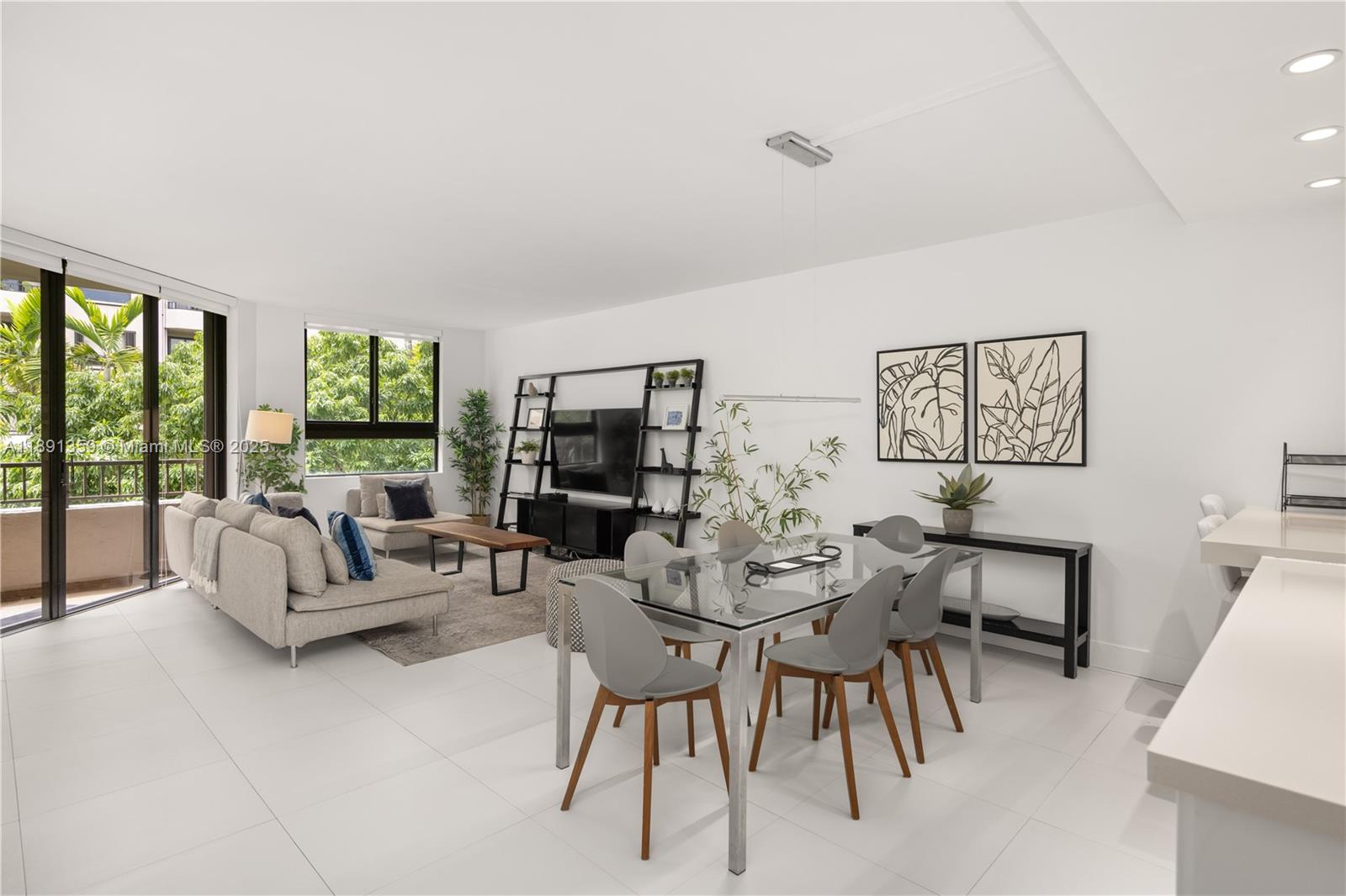 A bright, open-concept living and dining area features white tile floors and modern furniture — 101 Crandon Blvd # 379, Key Biscayne FL 33149, KEY BISCAYNE, FL