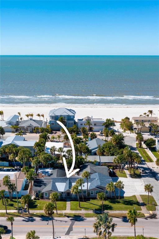 An aerial view shows a single-story house with a gray roof near the beach — 848 MANDALAY AVENUE, CLEARWATER BEACH, FL