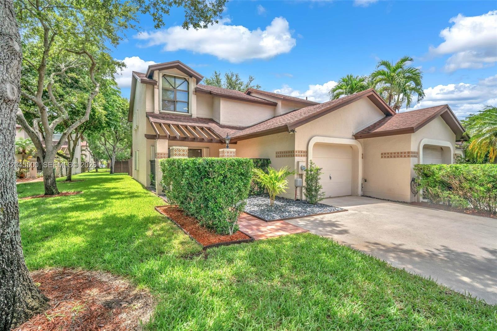 A two-story suburban house with a tan stucco exterior, brown roof, and attached garage — 10060 SW 137th Ct, Miami FL 33186, MIAMI, FL