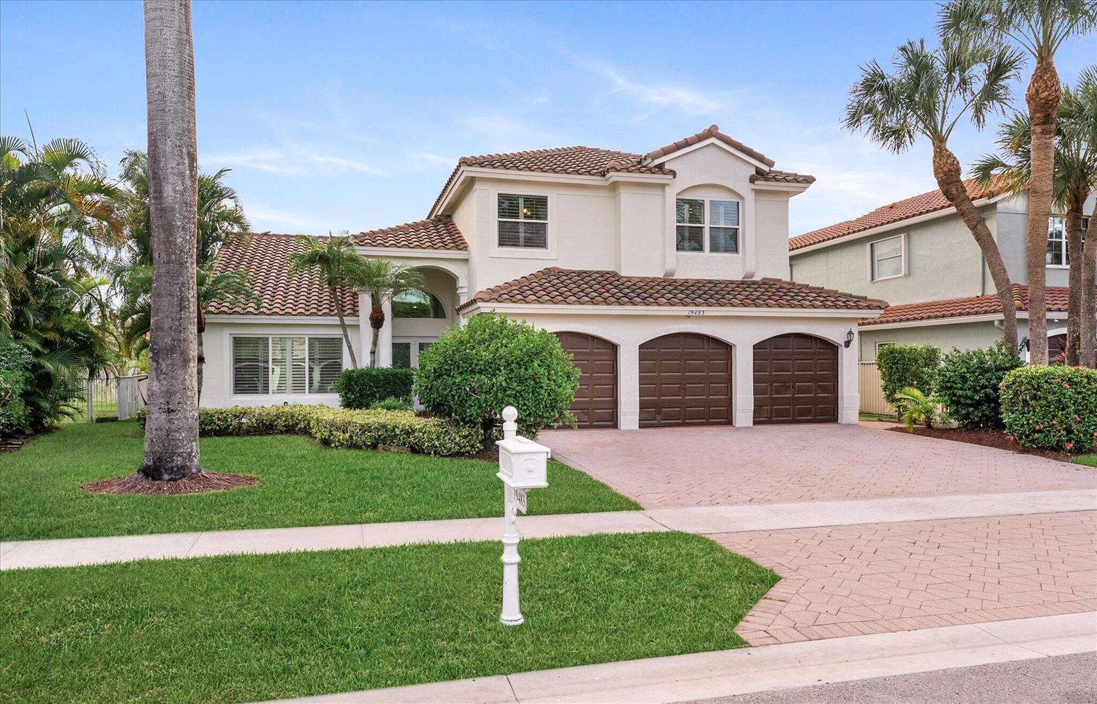 A two-story house with a three-car garage, tile roof, and a paved driveway — 19483 Black Olive Lane, Boca Raton FL 33498, BOCA RATON, FL