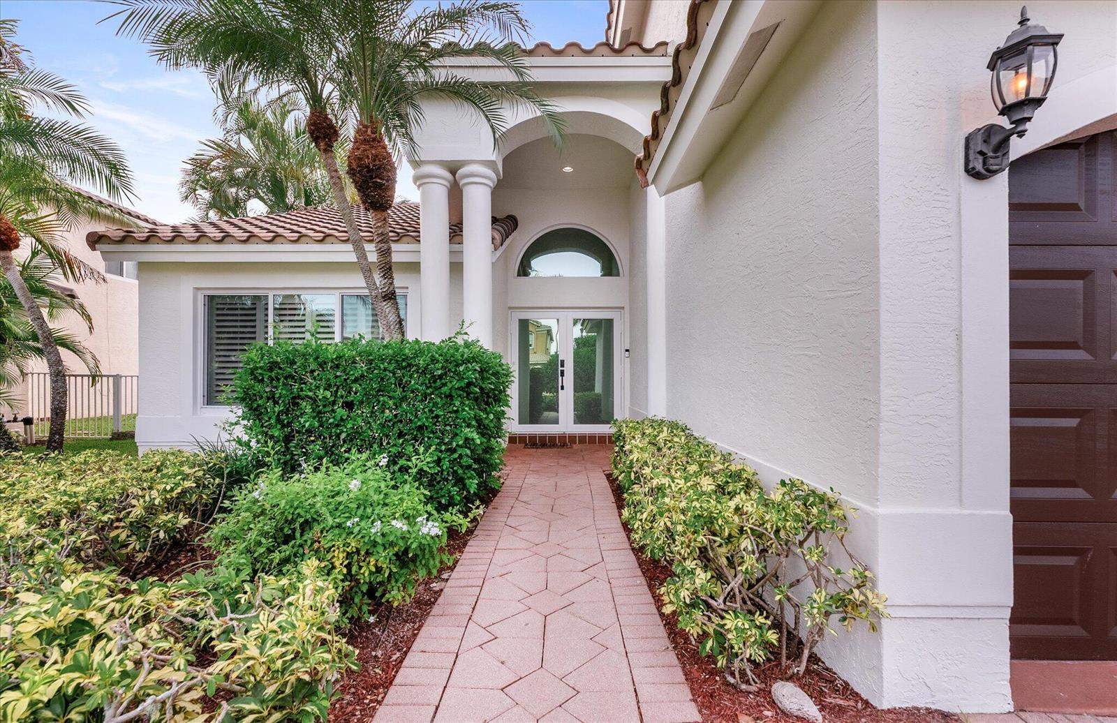 A paved walkway leads to the white double front doors of a house with columns — 19483 Black Olive Lane, Boca Raton FL 33498, BOCA RATON, FL