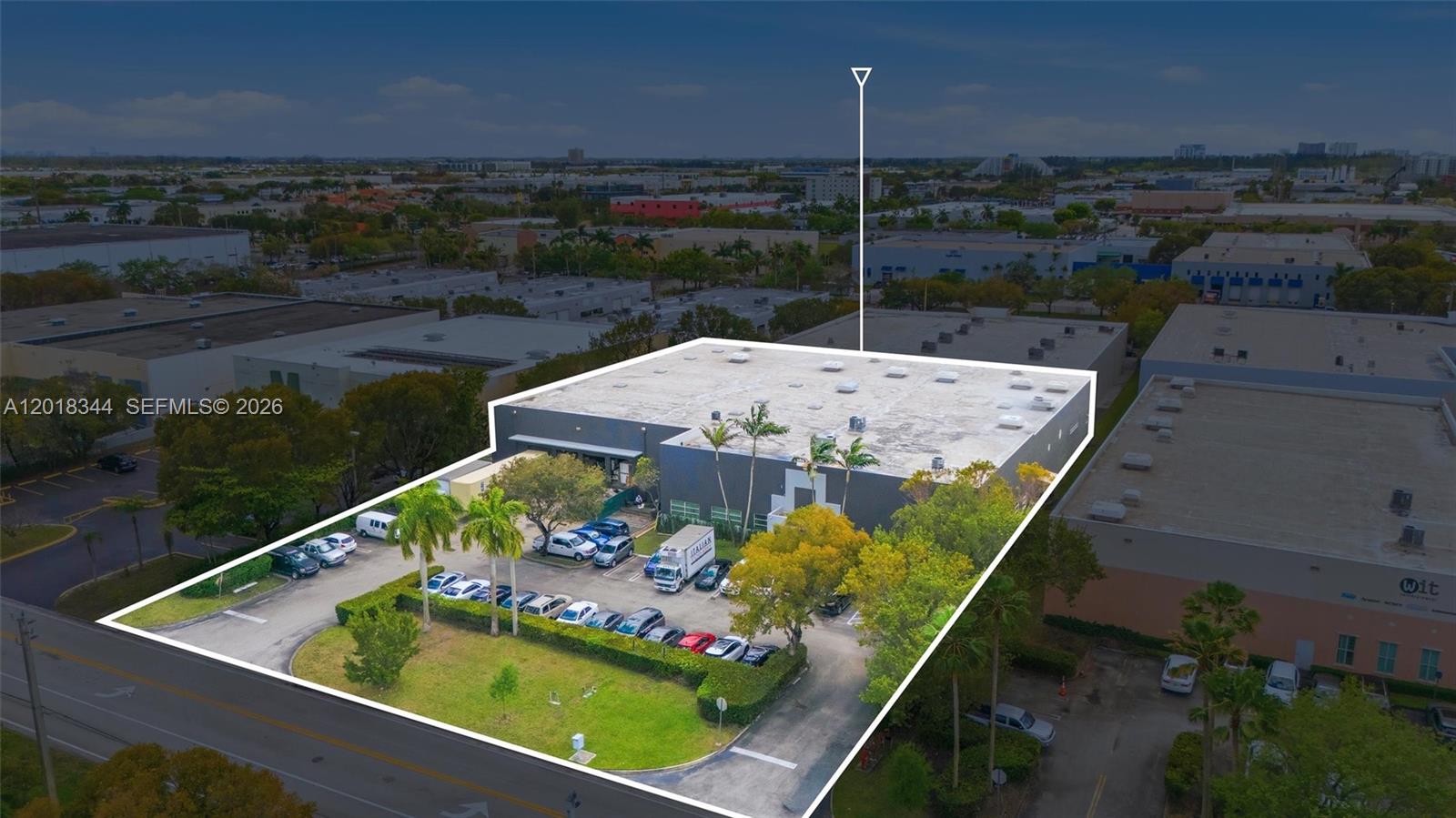 An aerial view shows a commercial warehouse building with a parking lot and landscaping — 10880 NW 30th St, Doral FL 33172, DORAL, FL