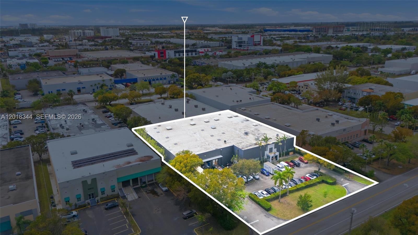 An aerial view shows a commercial warehouse building with a parking lot and landscaping — 10880 NW 30th St, Doral FL 33172, DORAL, FL