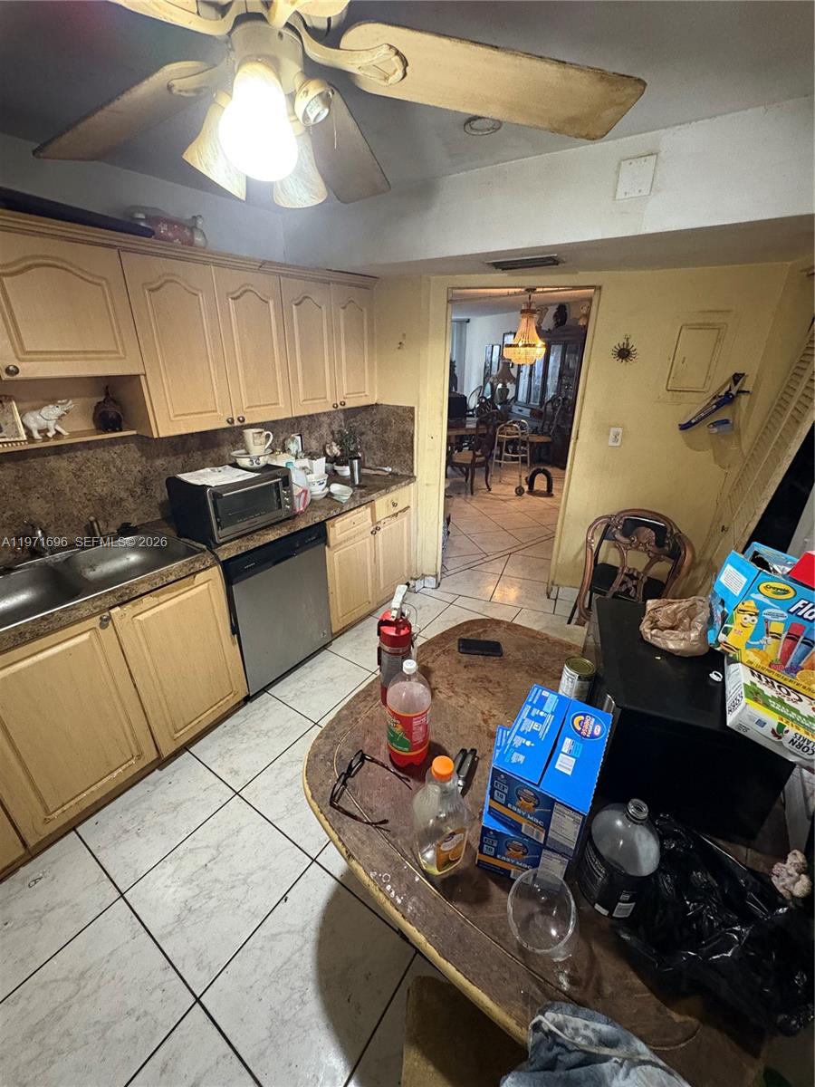 A kitchen with light wood cabinets, tile flooring, and a central island with groceries — 1401 NE 191st St # D204, Miami FL 33179, MIAMI, FL
