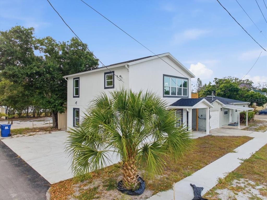 A single-story house with a light gray exterior, a garage, and a front porch — 4651 22ND AVENUE N, ST PETERSBURG, FL
