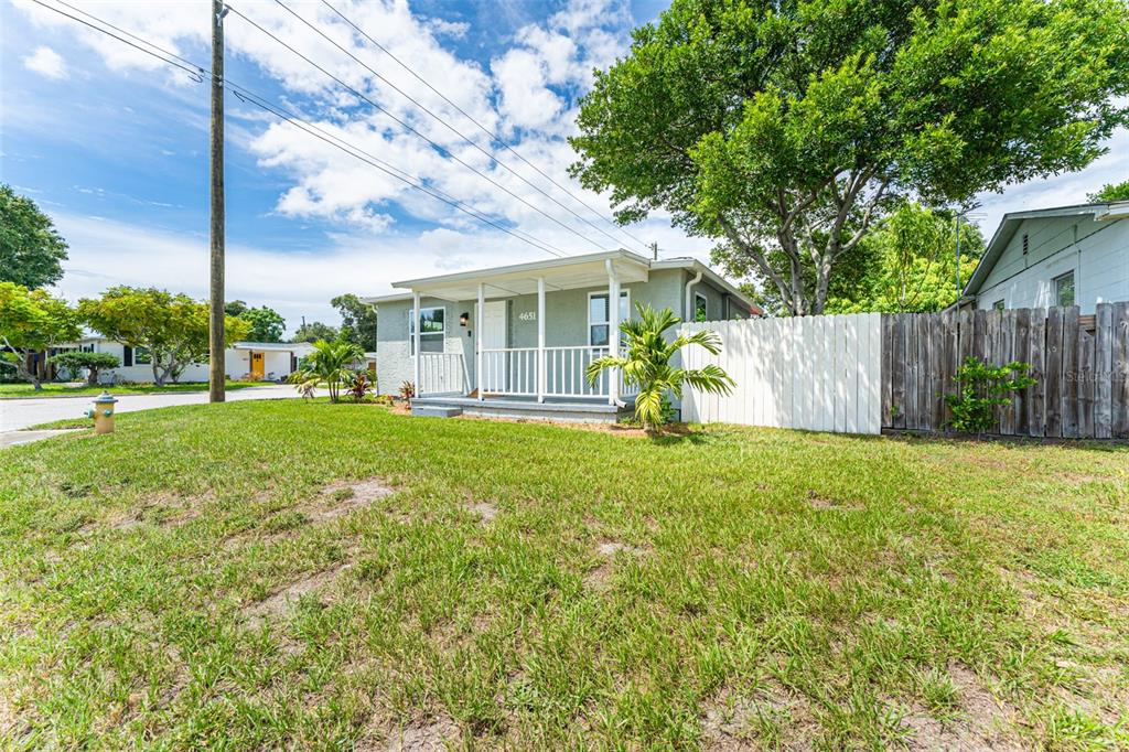 A single-story house with a light green stucco exterior, a garage, and a front lawn — 4651 22ND AVENUE N, ST PETERSBURG, FL