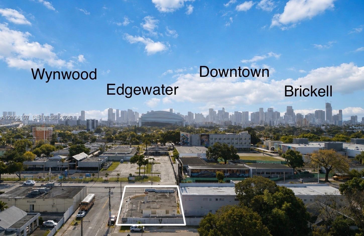 An aerial view shows a small, flat-roofed building outlined in white amidst a city landscape — 470 NW 22nd Ave, Miami FL 33125, MIAMI, FL