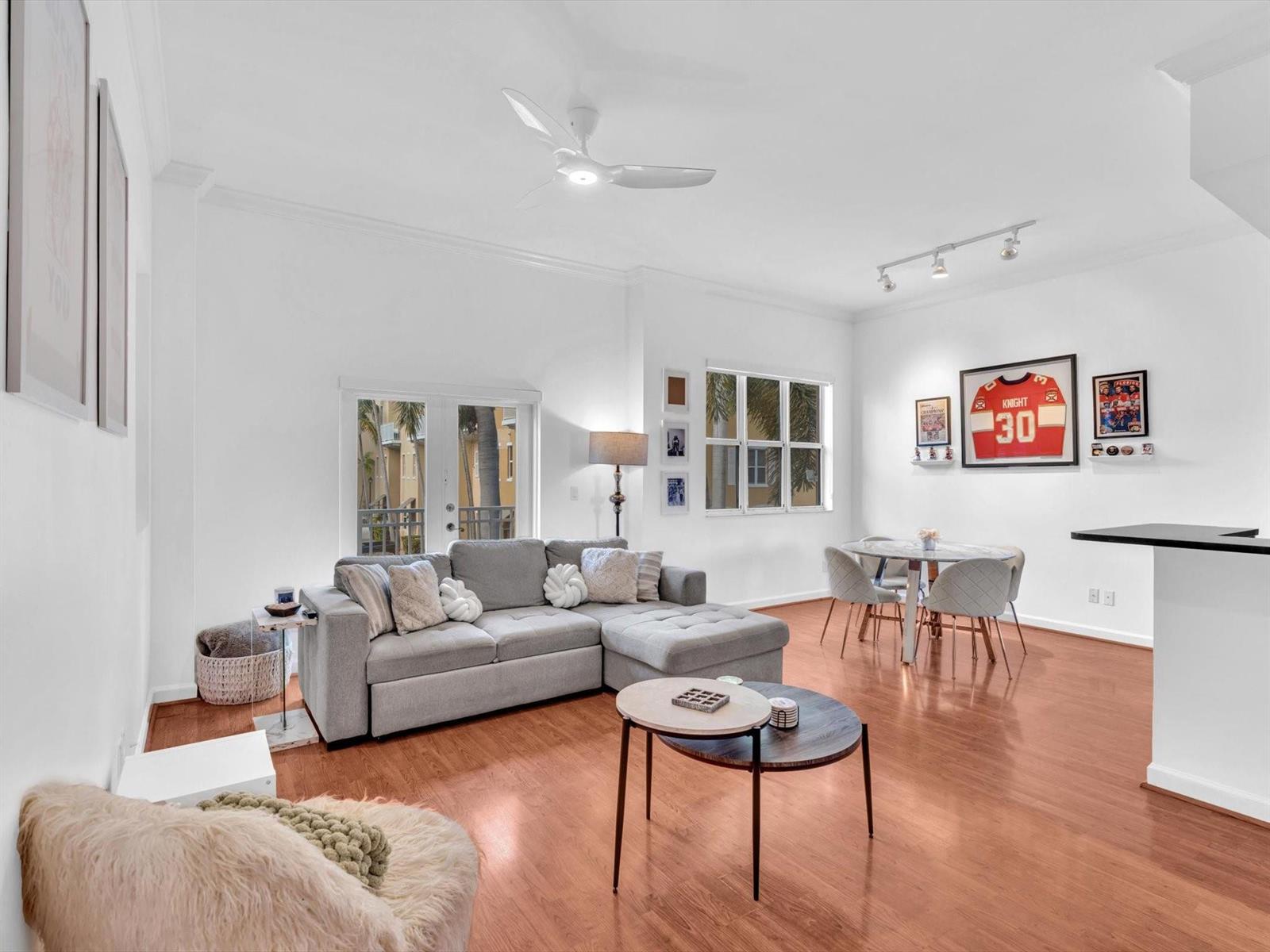 A living room with a gray sectional sofa, a round dining table, and hardwood floors — 2329 Vintage Drive # 2329, Lighthouse Point FL 33064, LIGHTHOUSE POINT, FL