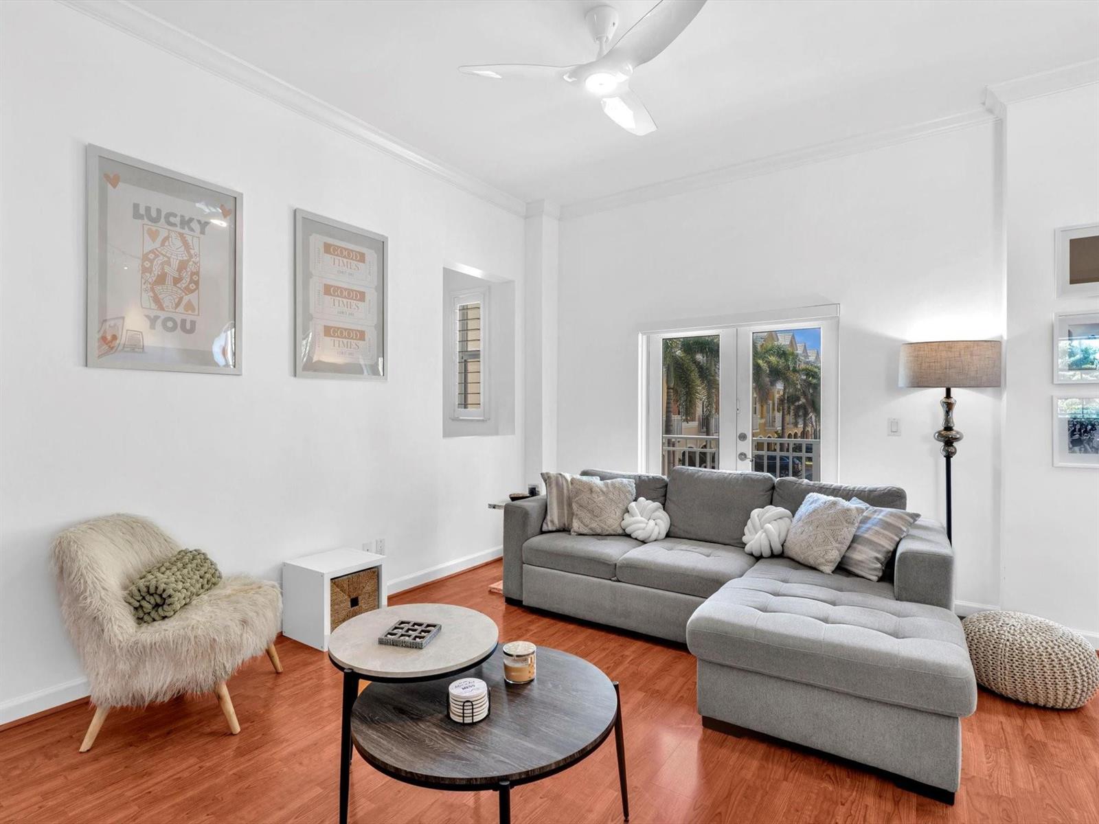 A living room features a grey sectional sofa, two round coffee tables, and hardwood floors — 2329 Vintage Drive # 2329, Lighthouse Point FL 33064, LIGHTHOUSE POINT, FL