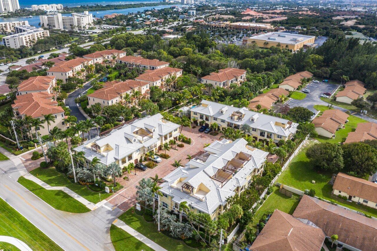 An aerial view of a residential complex with multiple buildings, palm trees, and paved driveways — 3770 County Line Road # C1, Tequesta FL 33469, TEQUESTA, FL