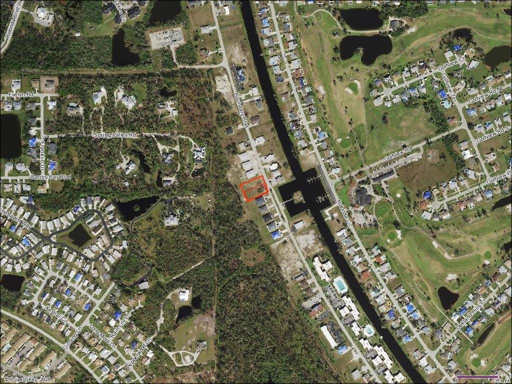 This is an aerial map showing a residential lot highlighted in red along a canal — 121 & 123 BOUNDARY BOULEVARD, ROTONDA WEST, FL