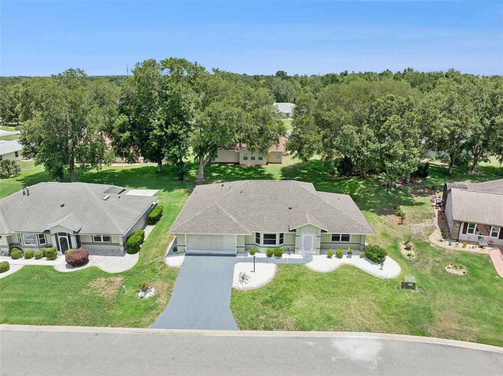 An aerial view shows a single-story house with a gray roof and a paved driveway — 6419 BORG STREET, LEESBURG, FL