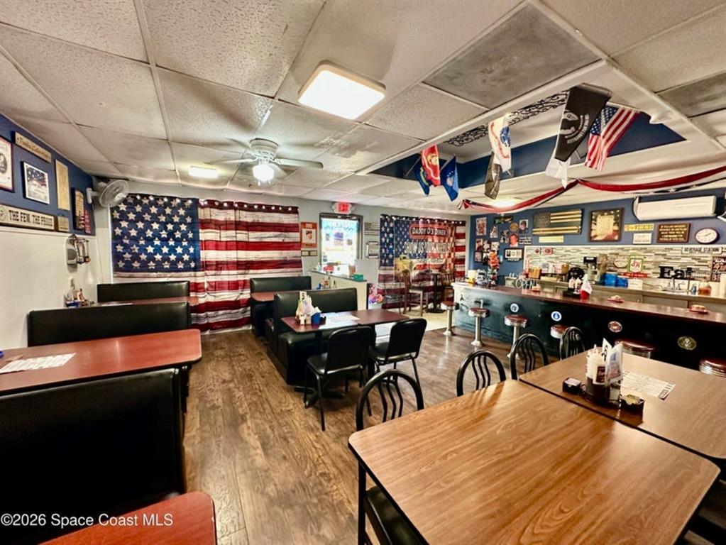 A restaurant dining area features booth seating, a service counter, and patriotic decor — 722 WEST AVENUE, COCOA, FL
