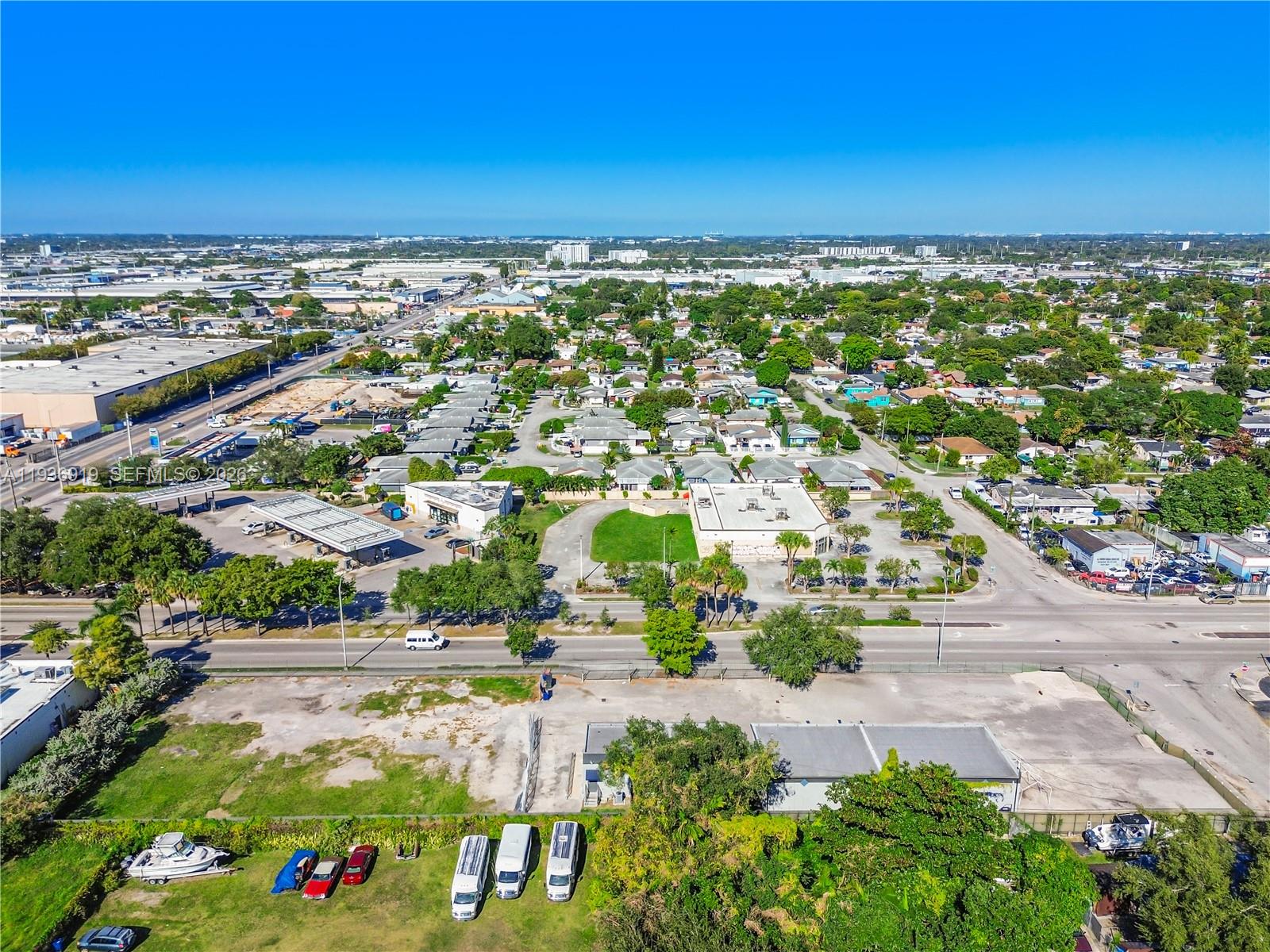 An aerial view shows a commercial lot with a building, parking, and surrounding neighborhood — 3130 NW 62nd St, Miami FL 33147, MIAMI, FL