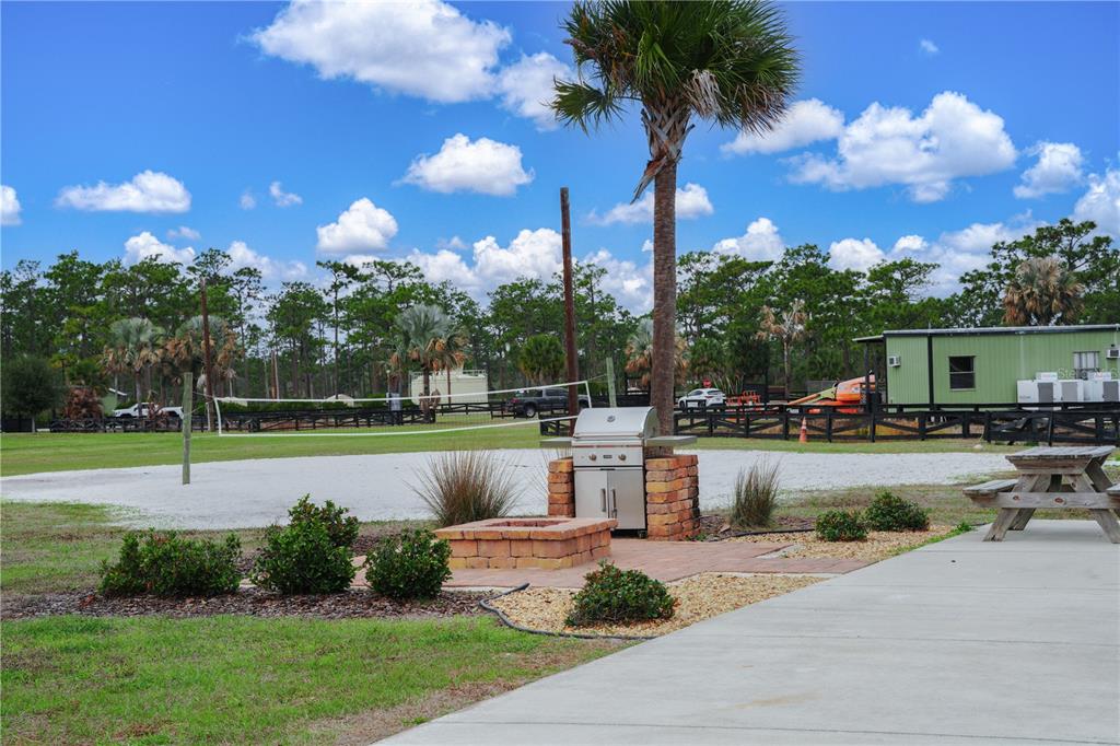 An outdoor area features a grill, a fire pit, a volleyball net, and a picnic table — 0 HIGHWAY 630 E UNIT 7, LAKE WALES, FL