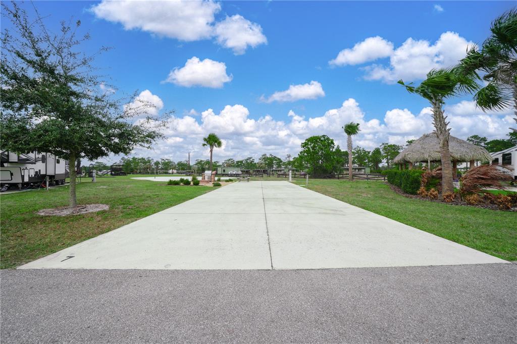 A concrete RV pad sits in an open grassy area with trees and a gazebo — 0 HIGHWAY 630 E UNIT 7, LAKE WALES, FL