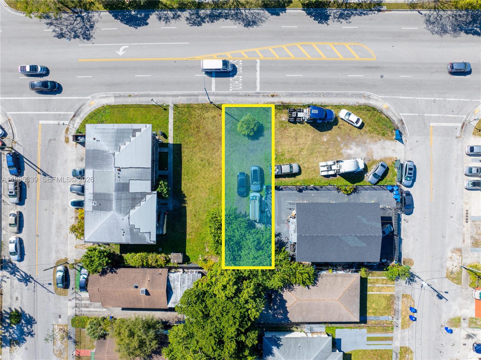 An aerial view shows a rectangular vacant lot outlined in yellow between two buildings — 6435 NW 12th Ave, Miami FL 33150, MIAMI, FL