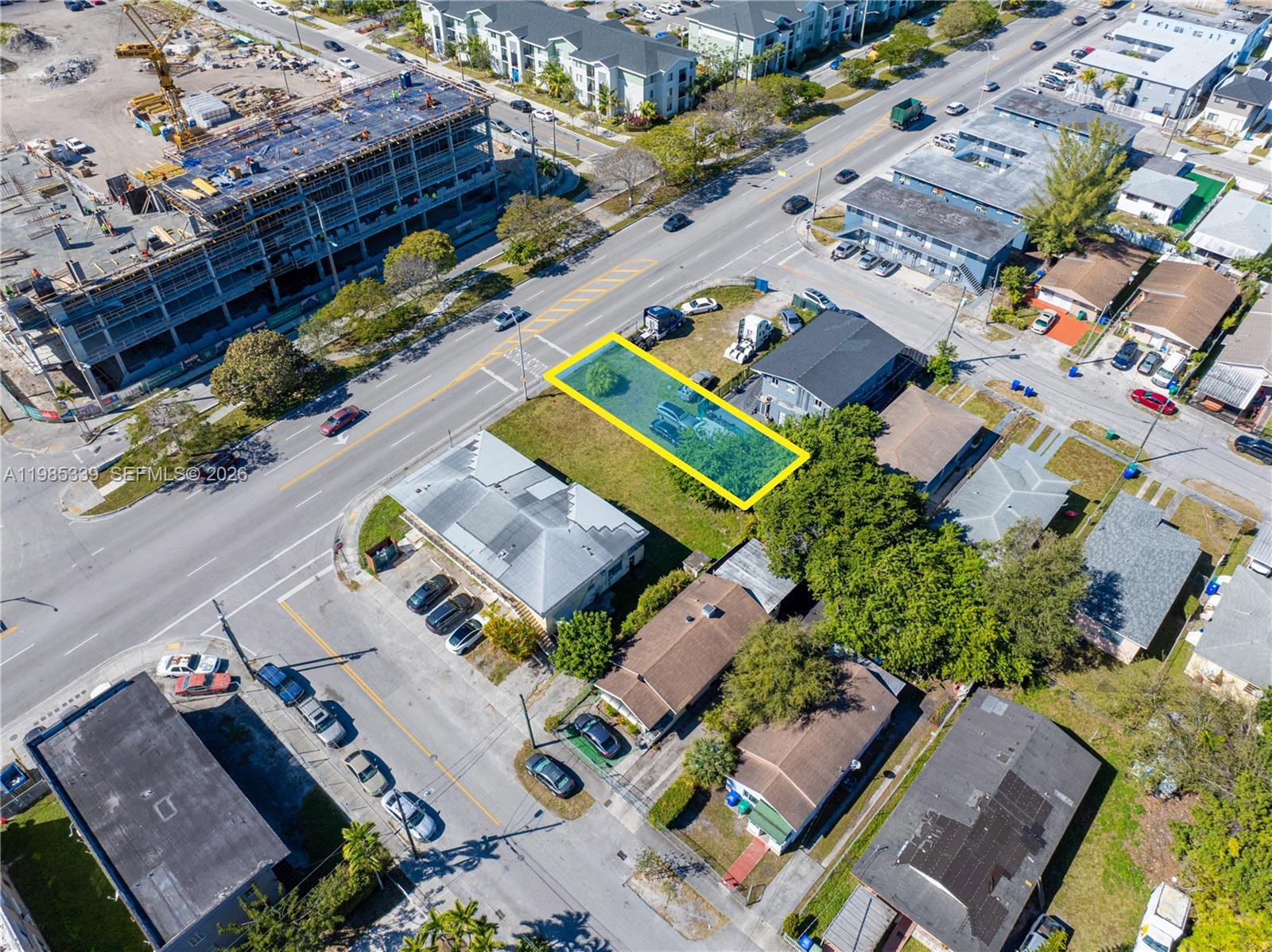 An aerial view shows a rectangular vacant lot highlighted in yellow between two existing buildings — 6435 NW 12th Ave, Miami FL 33150, MIAMI, FL