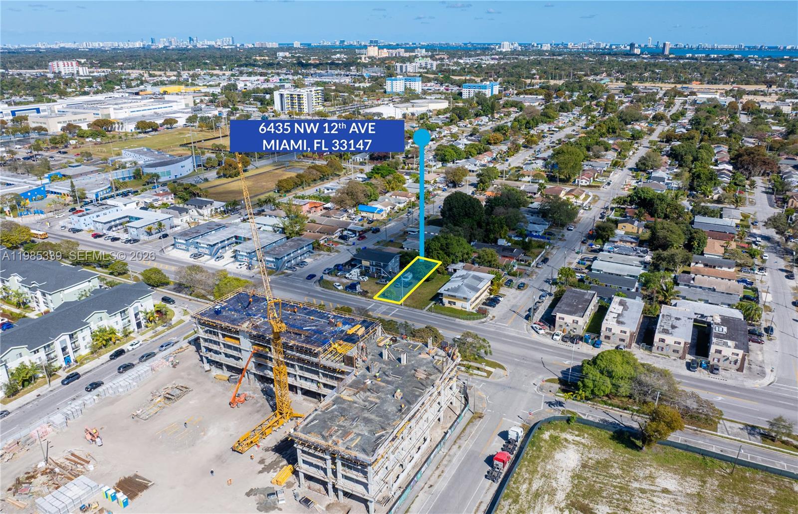An aerial view shows a highlighted vacant lot near a large active construction site — 6435 NW 12th Ave, Miami FL 33150, MIAMI, FL