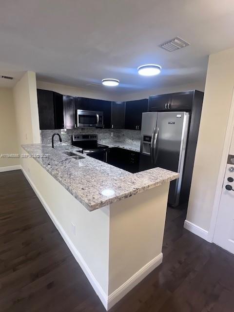 A kitchen with dark cabinets, granite countertops, stainless steel appliances, and dark wood flooring — 20005 NE 3rd Ct # 6, Miami FL 33179, MIAMI, FL