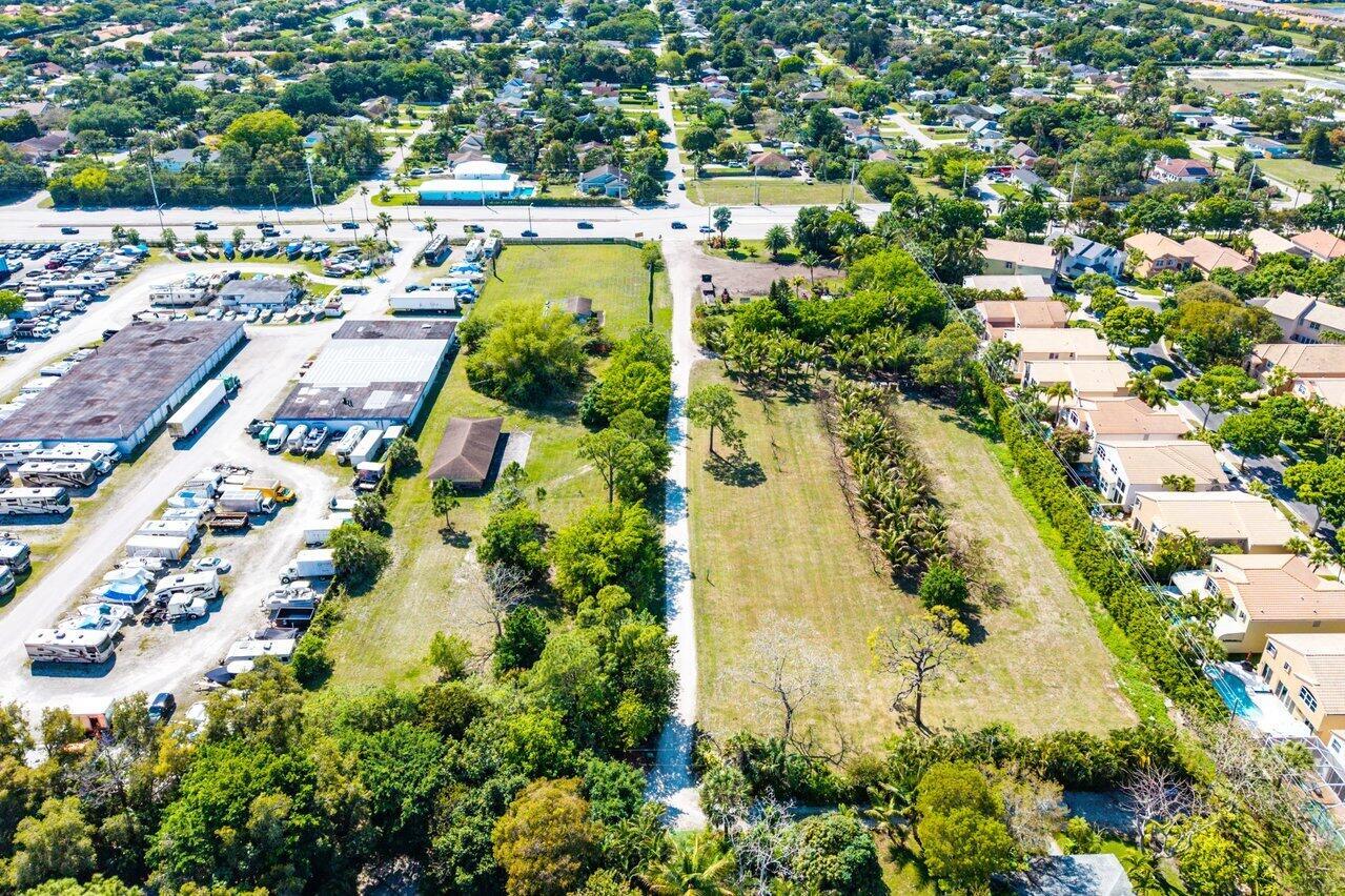 An aerial view shows a large vacant lot adjacent to a vehicle storage area and houses — 0 S Military Trail, Delray Beach FL 33415, DELRAY BEACH, FL