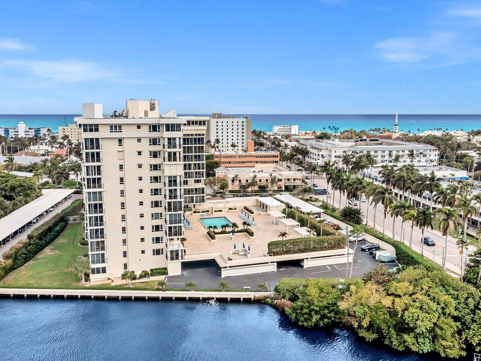 An aerial view of a high-rise apartment building with a pool deck and waterfront — 50 East Road # 12f, Delray Beach FL 33483, DELRAY BEACH, FL