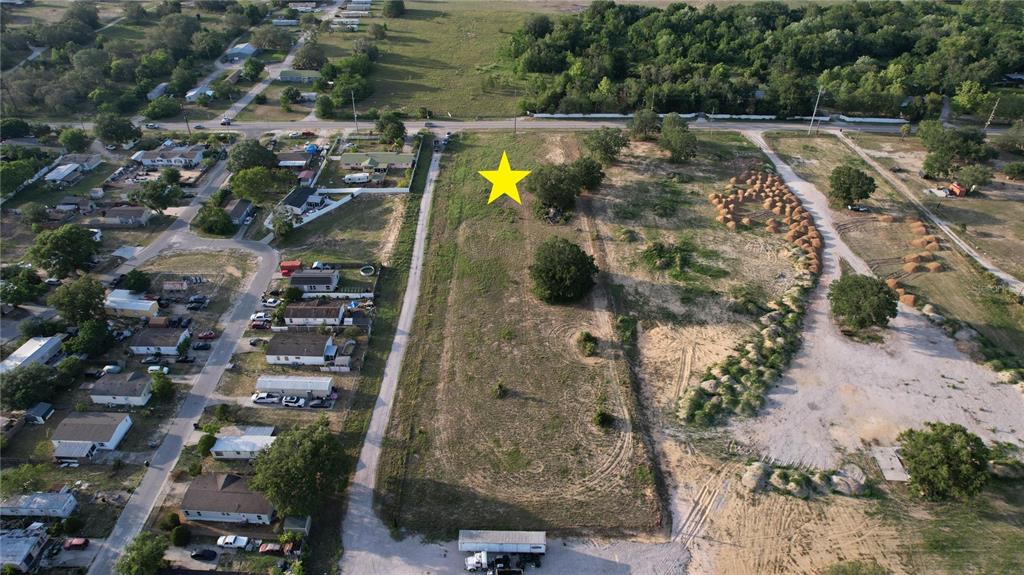 An aerial view shows a vacant rectangular lot marked with a yellow star — 5645 JOHNSON AVENUE E, HAINES CITY, FL
