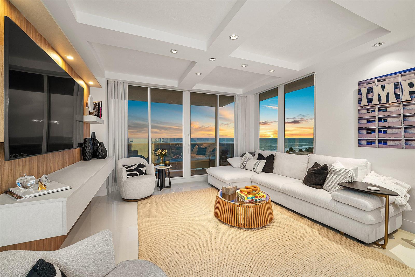 A modern living room features a white sectional sofa, wood coffee table, and ocean views — 700 S Ocean Boulevard # 705, Boca Raton FL 33432, BOCA RATON, FL