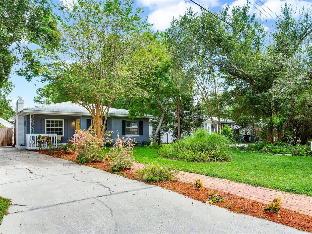 A gray single-story house with a concrete driveway and a brick walkway in the front — 221 N CLEARVIEW AVENUE, TAMPA, FL