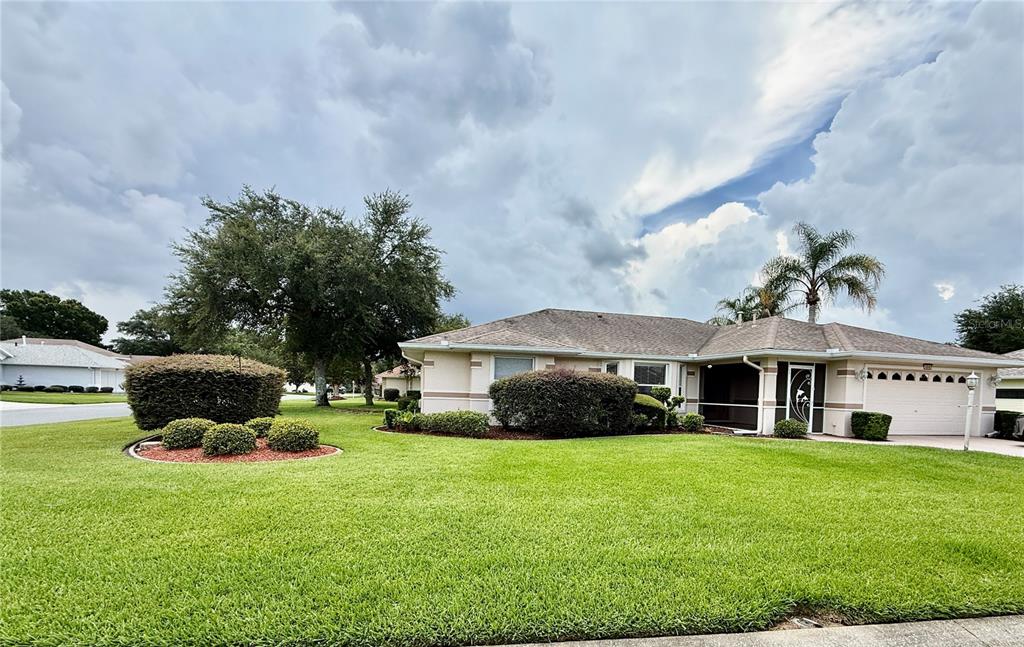 An aerial view shows a suburban neighborhood with single-family homes, green lawns, and paved streets — 4646 INVERNESS DRIVE, LEESBURG, FL