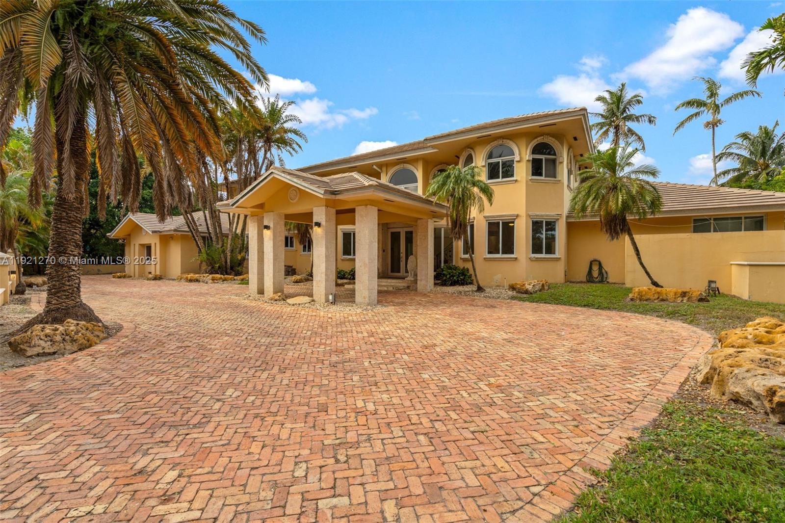 A two-story yellow house with a brick driveway and a covered entrance portico — 7225 Gleneagle Dr, Miami Lakes FL 33014, MIAMI LAKES, FL