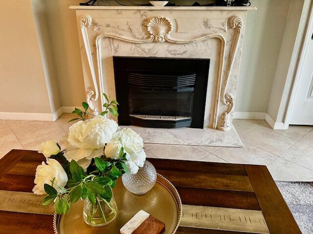 A marble fireplace with a floral bouquet on a wooden coffee table in a room — 550 NW 78th Terrace # 107, Margate FL 33063, MARGATE, FL
