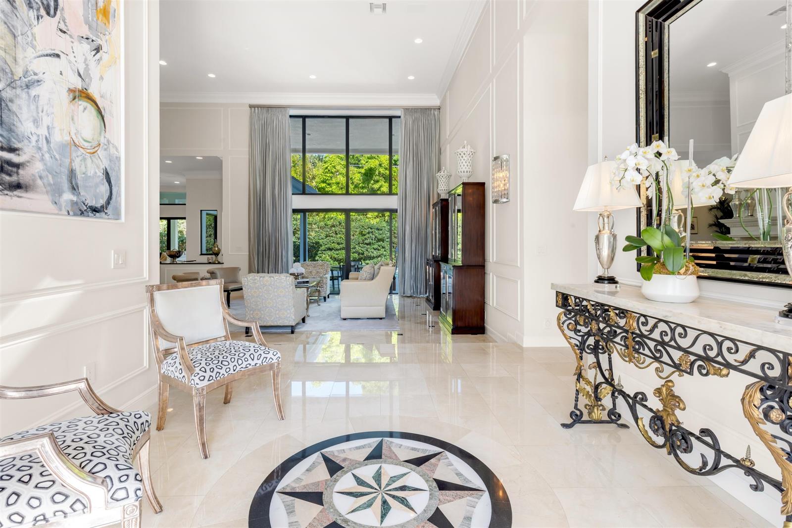 A bright foyer features a marble floor with a compass inlay and a decorative console table — 4275 Sanctuary Lane, Boca Raton FL 33431, BOCA RATON, FL