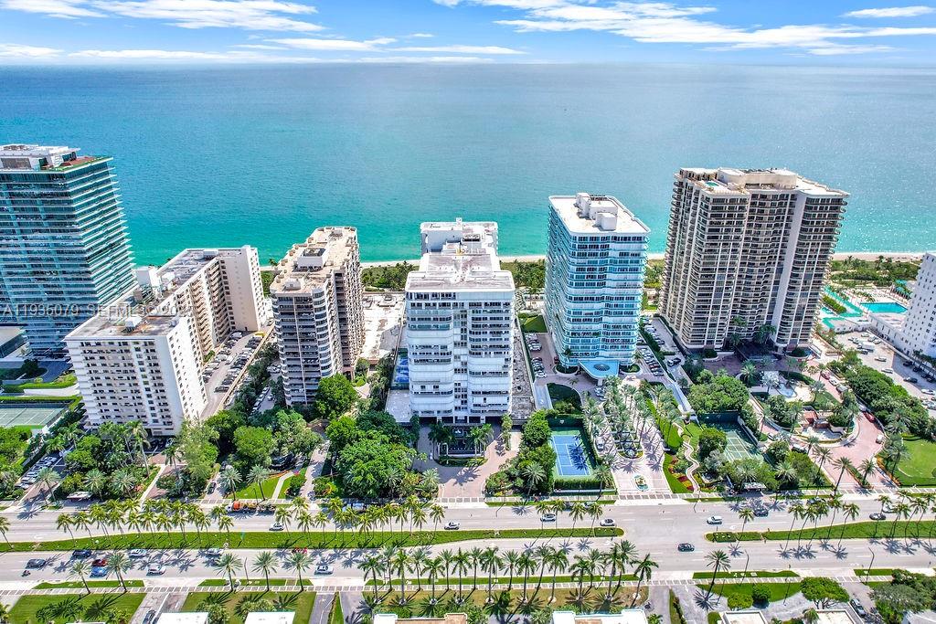 An aerial view shows several high-rise residential buildings situated along a sandy beach — 10155 Collins Ave # 1106, Bal Harbour FL 33154, BAL HARBOUR, FL