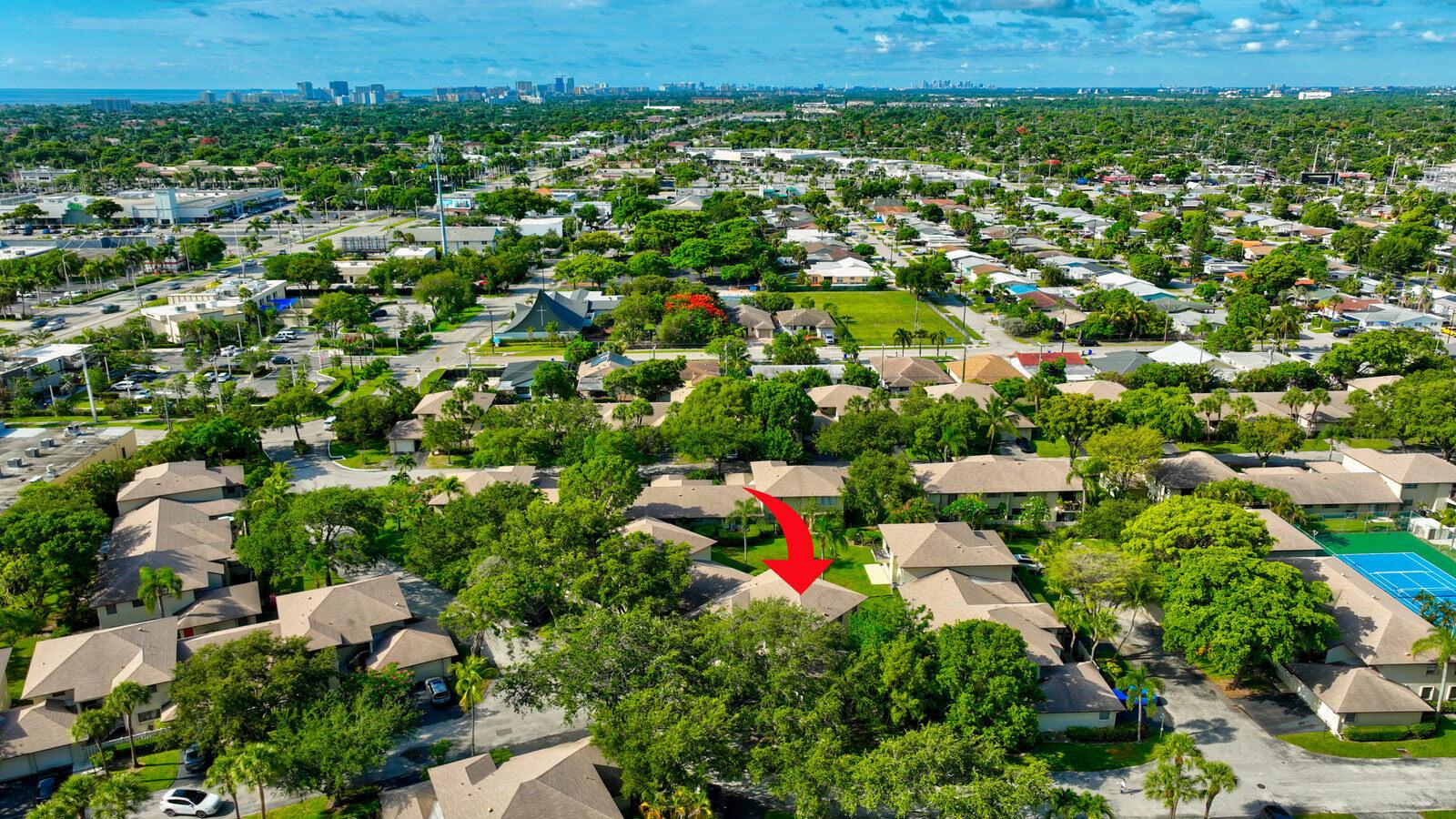 An aerial view of a residential neighborhood with a red arrow pointing to a townhouse — 3951 NE 19th Road # 1701, Pompano Beach FL 33064, POMPANO BEACH, FL