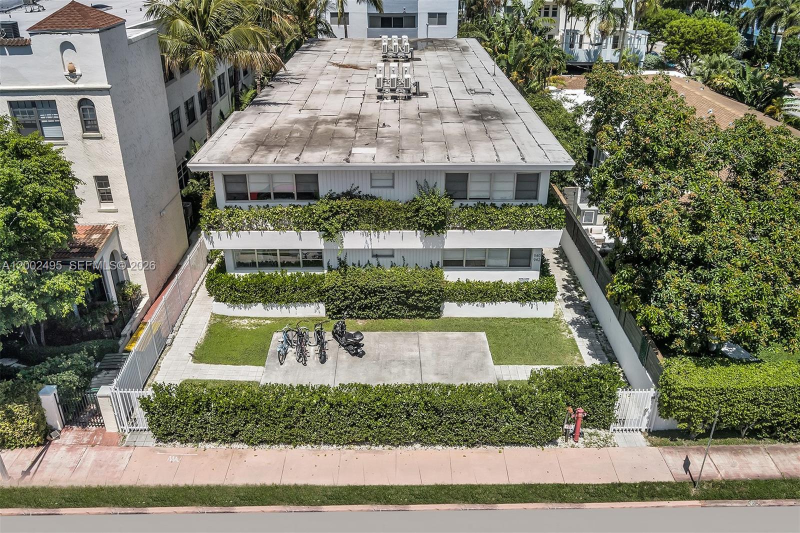 An aerial view shows a two-story apartment building with a flat roof and landscaping — 940 Michigan Ave # 4, Miami Beach FL 33139, MIAMI BEACH, FL